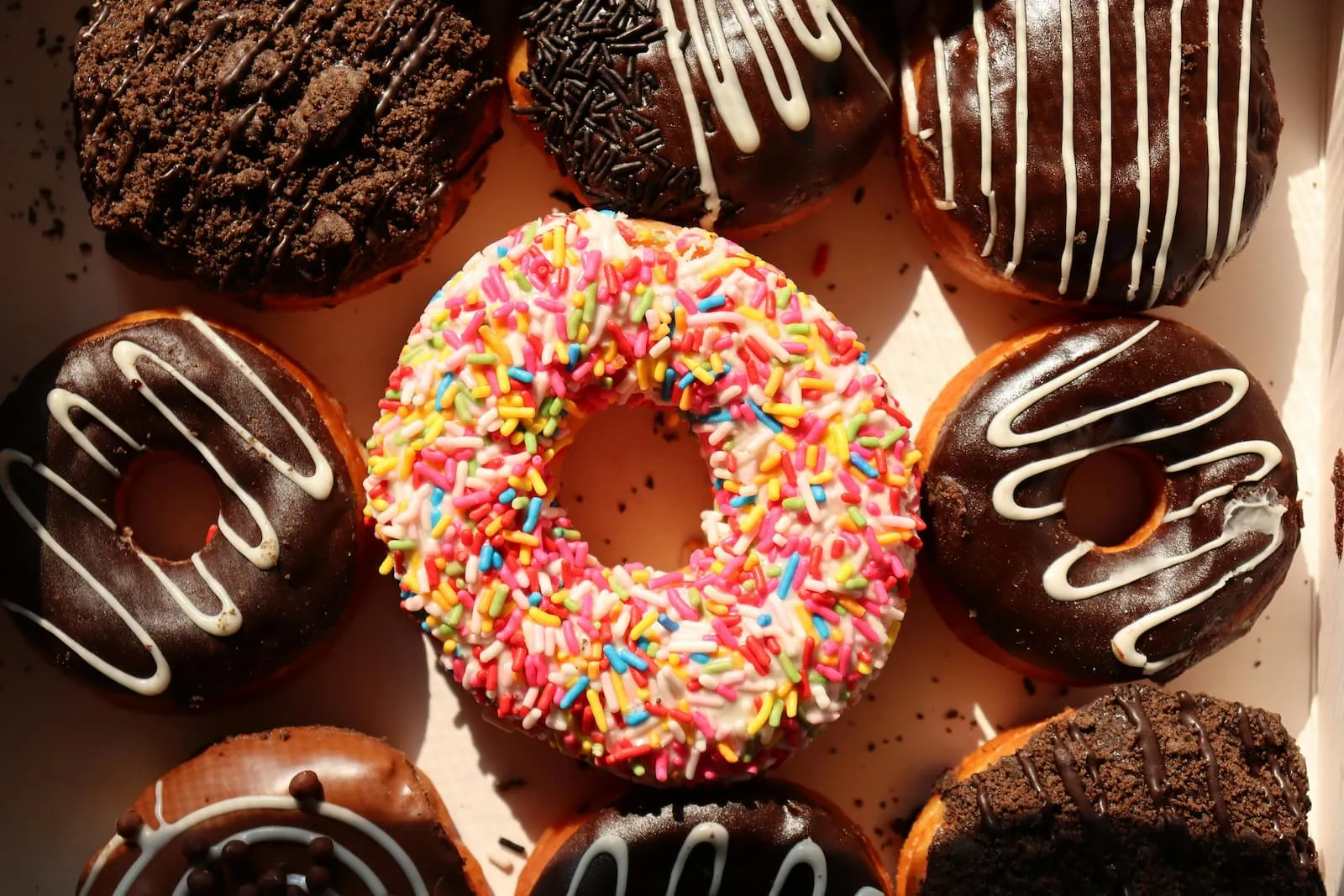 A box with several donuts in different colors.
