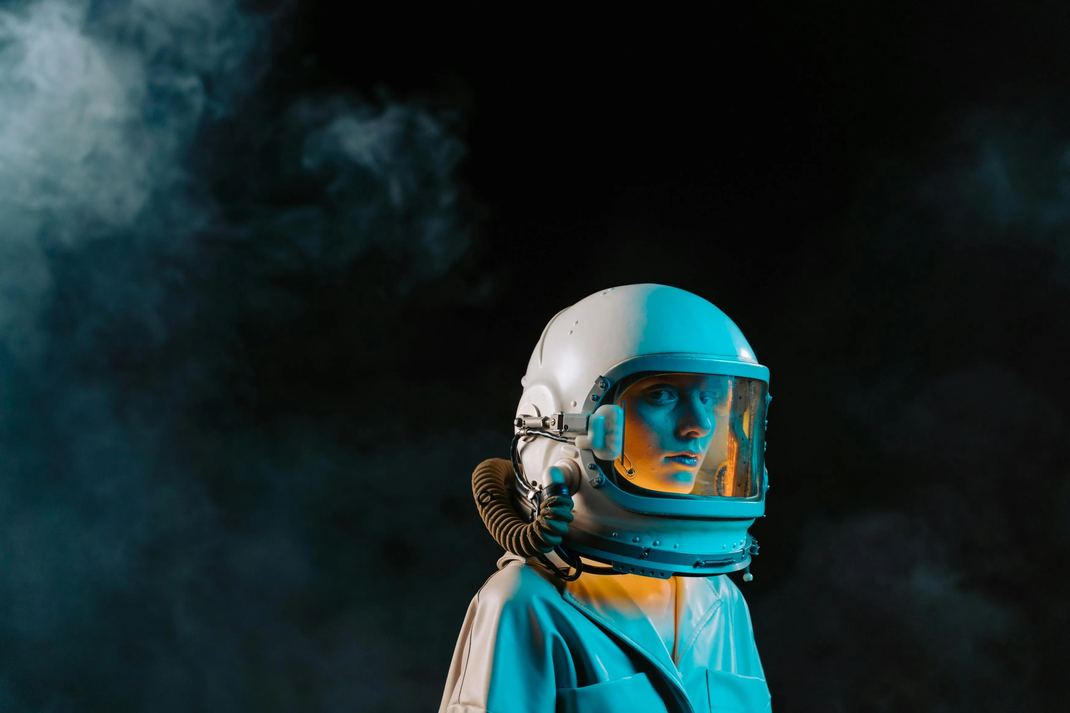 A man in a white leather coat, wearing an astronaut like helmet.