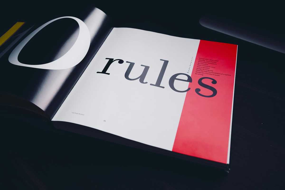 An open book on a table with the word rules clearly visible.